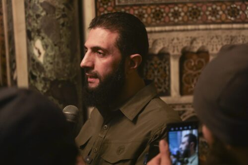 Who is the leader of the militants in Syria and what reputation does he enjoy?